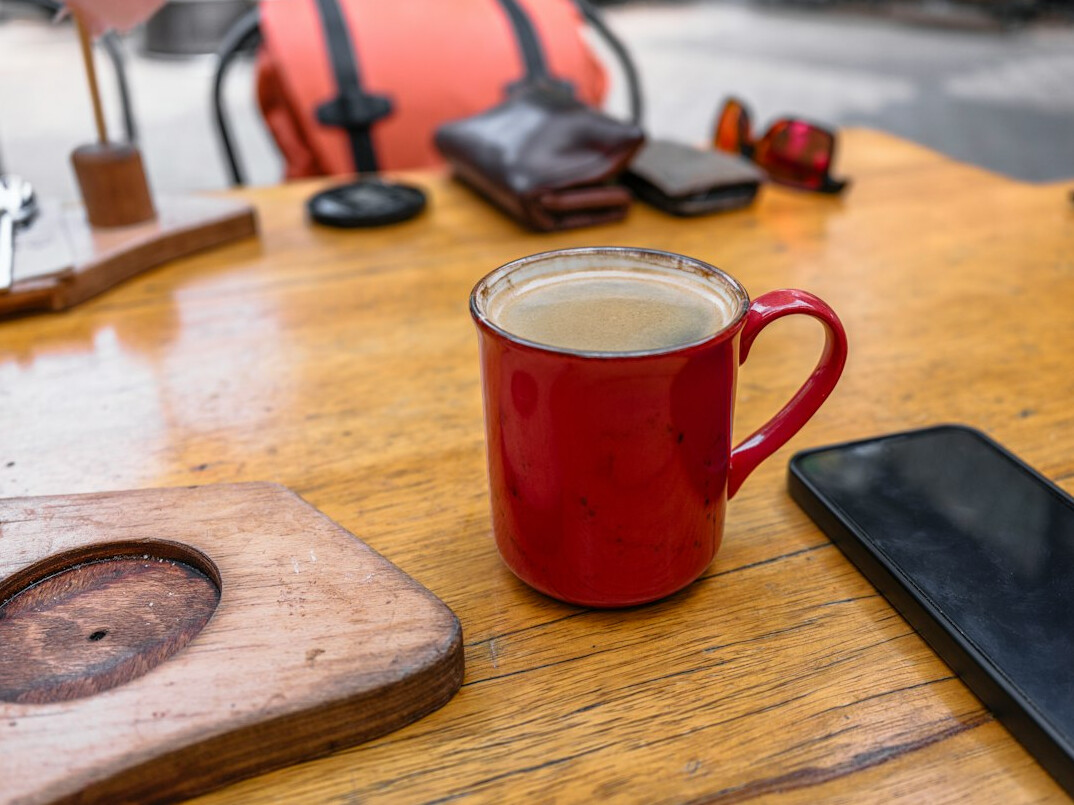 Laptop, notebook and coffee on a wooden table