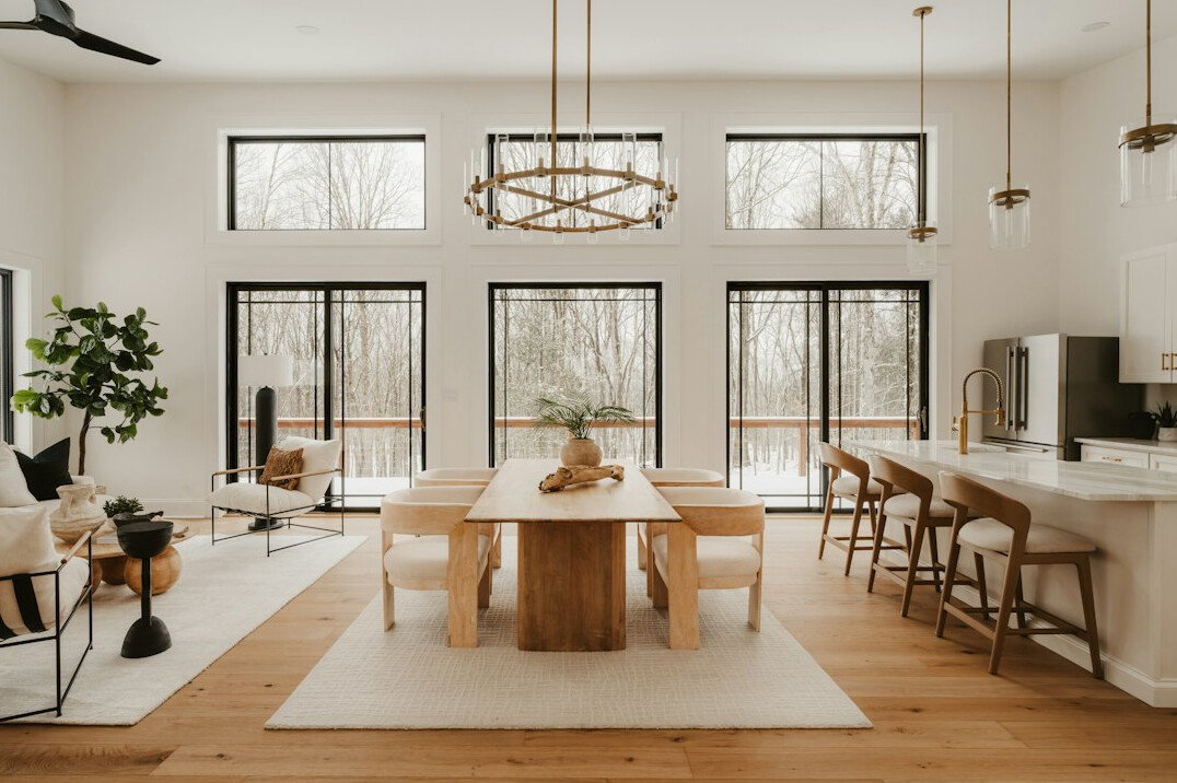 Bright modern open workspace with wooden tables and large windows